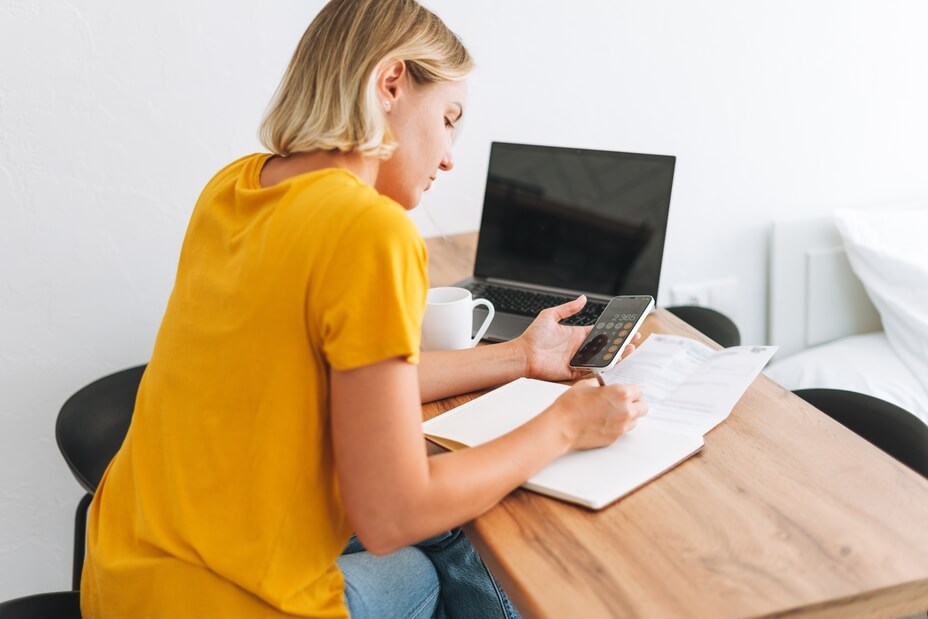 A woman looking to save money researches the question ‘What is the going rate for house cleaning in Canada?'